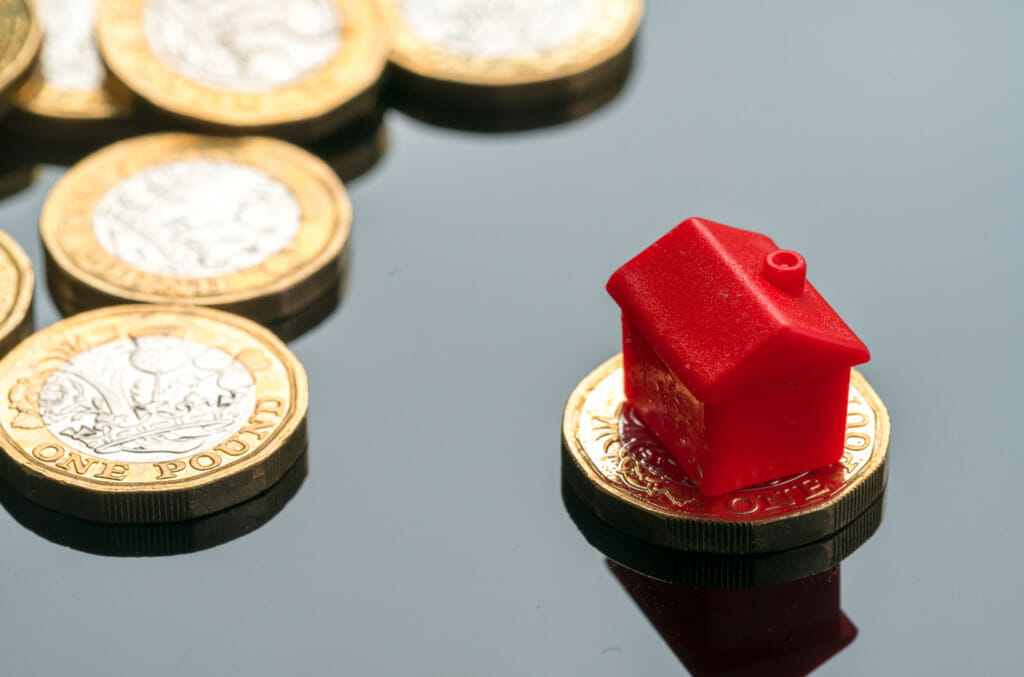 small red house figure on one pound coin