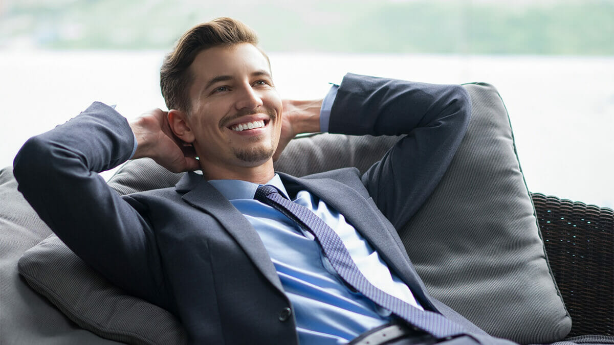 A businessman relaxing and smiling